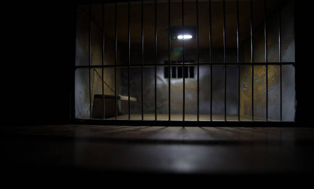 istock Jail or prison cell. Old grunge prison miniature. Dark prison interior creative decoration. Empty cell. Selective focus Obsolete gray grunge concrete room. 1298207660