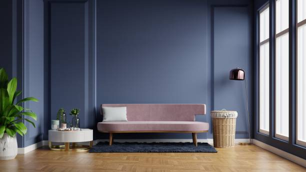 istock Interior of light room with sofa on empty dark blue wall background. 1298207817