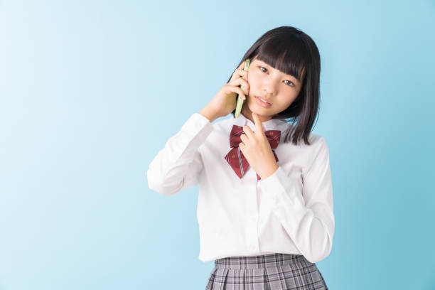 istock girl student who talks on the telephone,School uniform,think, 1298207890