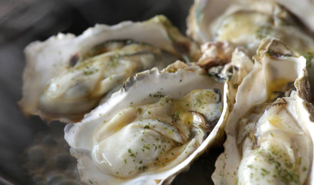 istock Grilled oysters with shells in butter and soy sauce 1298210524
