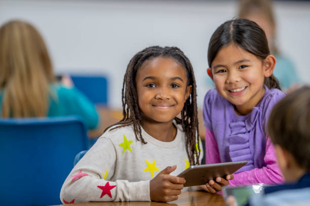 istock Elementary school girls smiling 1298212154