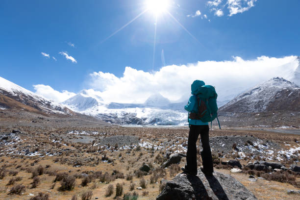 istock Woman backpacker hiking in winter high altitude mountains 1298219263