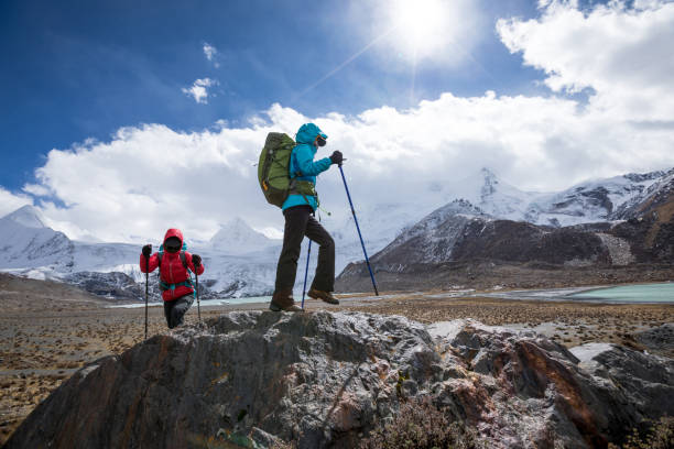 istock Two women hikers hiking  in winter mountains 1298219929