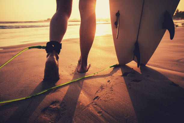 istock Woman surfer with surfboard ready to surf on a beach 1298221003