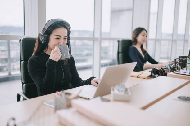 istock asian chinese beautiful women drinking coffee working in open plan office observing with new SOP and social distancing illness prevention safety precautions 1298222695