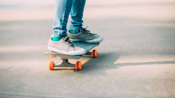 istock Skateboarder skateboarding outdoors on sunny morning 1298224948
