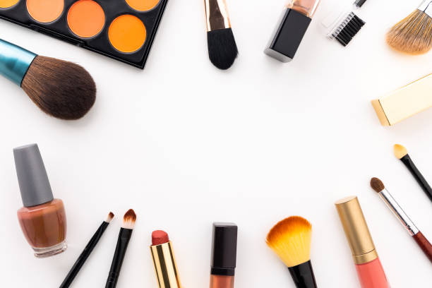 istock Plenty of makeup on the white table with eyelash brush, eye shadow, lipstick with copy space for text. 1298225536