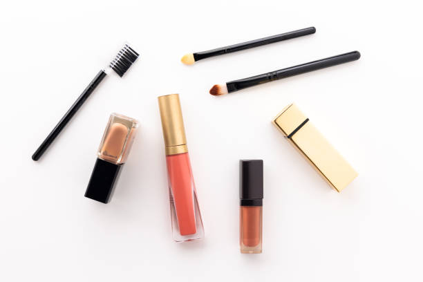 istock Plenty of makeup on the white table with eyelash brush, eye shadow, lipstick. 1298225585