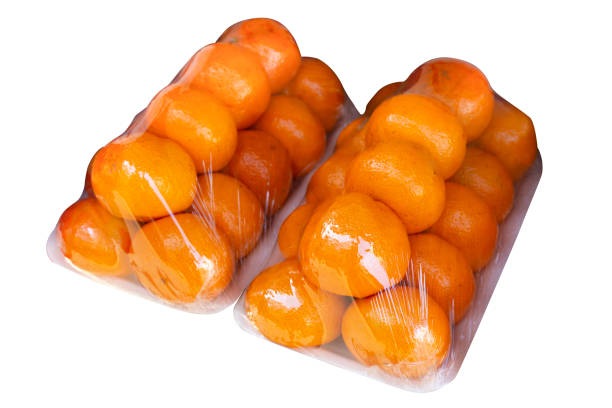 Mandarin orange in plastic wrap isolated on white