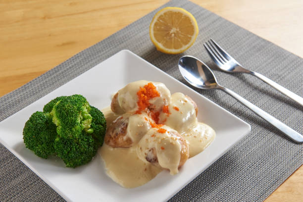 istock Scallops with salad dressing, served with broccoli 1298226744