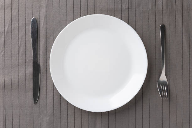 istock White empty plates set on the table with knives and forks and tablecloths. Ready to eat 1298227020