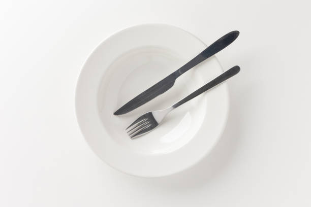 istock The empty white plates were set on the table with knives and forks. Ready to eat 1298227032