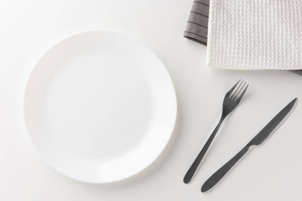 istock White empty plates set on the table with knives and forks and tablecloths. Ready to eat 1298227035