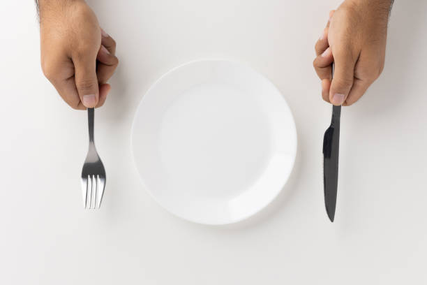 istock A man with a knife and fork to eat on the plate 1298227048