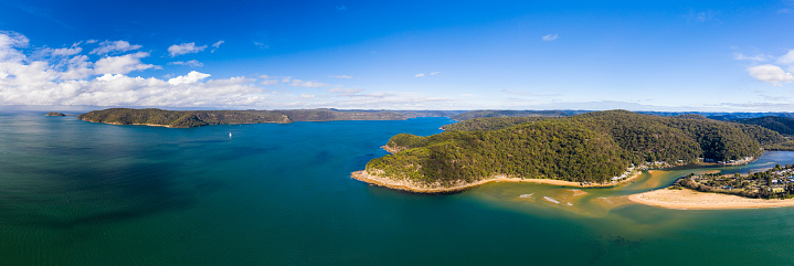 A view of the Hawkesbury river from the Central Coast, looking towards Sydney, West Head, with Patonga to the right, and a storm with clouds to the left.