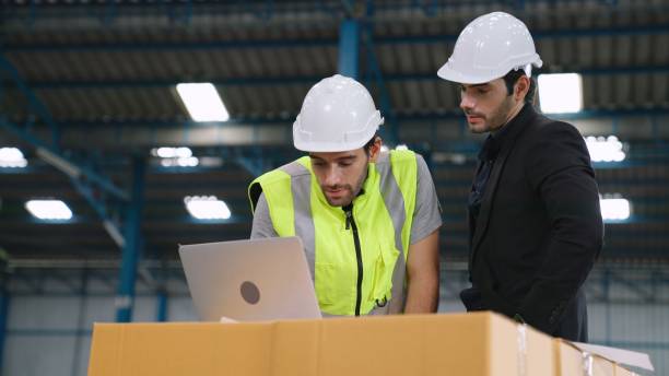 istock Two factory workers working and discussing manufacturing plan in the factory . 1298230321