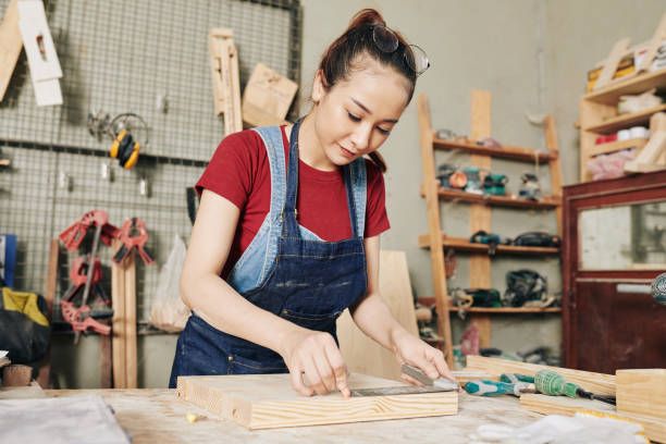 istock Carpenter measuring wooden board 1298235190