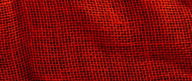 Background and texture of red sackcloth with stitches seam