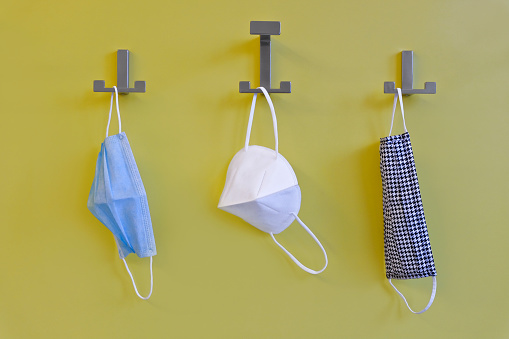 Disposable mask, FFP2 respirator (N95), self-made mouth and nose protection are hung up to dry.