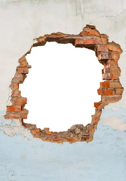 Photo of Broken hole in an old brick wall