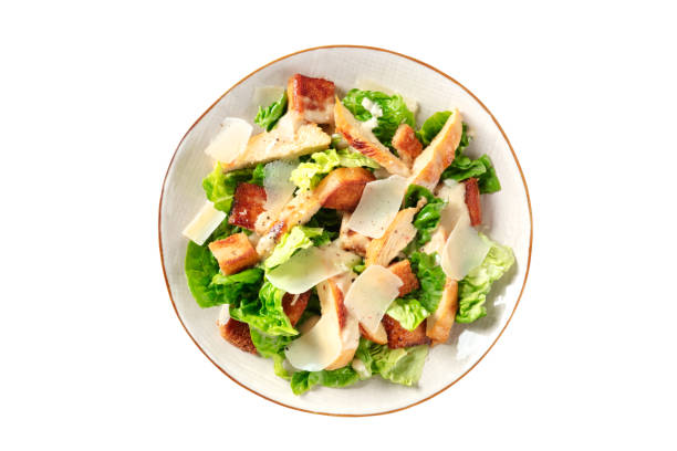 istock Caesar salad with grilled chicken, green lettuce and Parmesan 1298239382