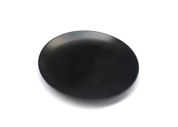 istock Empty ceramics black plate isolated on white background with clipping path 1298239613