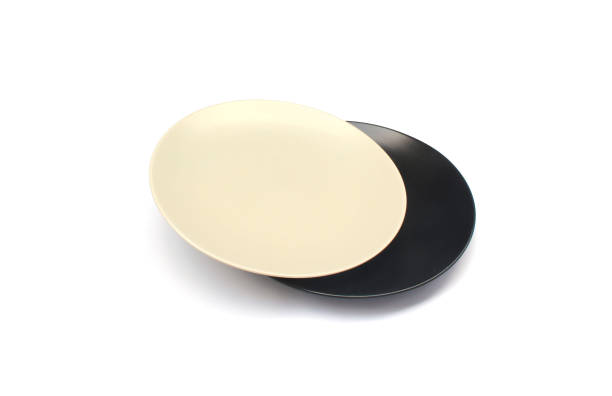 istock Empty ceramics white and black plate isolated on white background with clipping path 1298239621