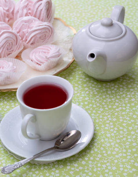 istock A white mug with a teapot next to a marshmallow. Selective focus. 1298241716