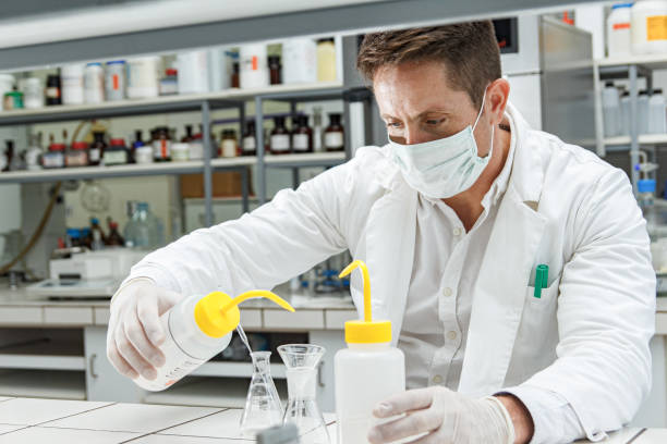 istock Male scientist mixing poisonous liquid in a laboratory. 1298241833