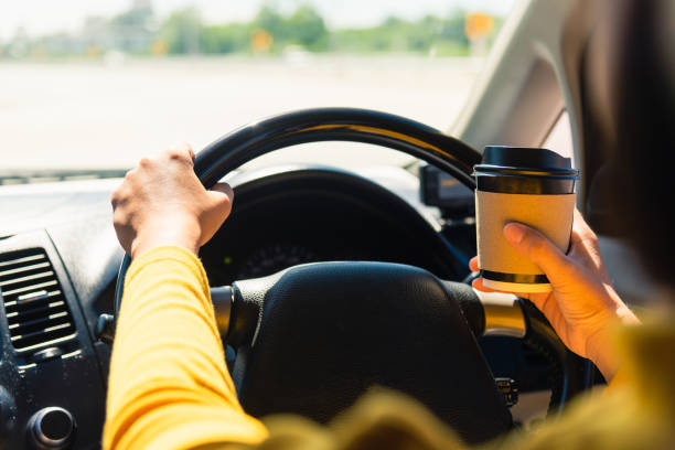 istock woman drinking hot coffee takeaway cup inside a car 1298243708
