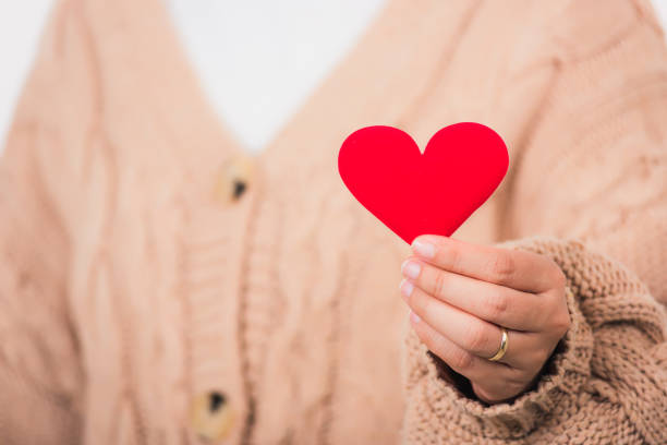 istock Female beauty hands holding modern a red heart 1298243773