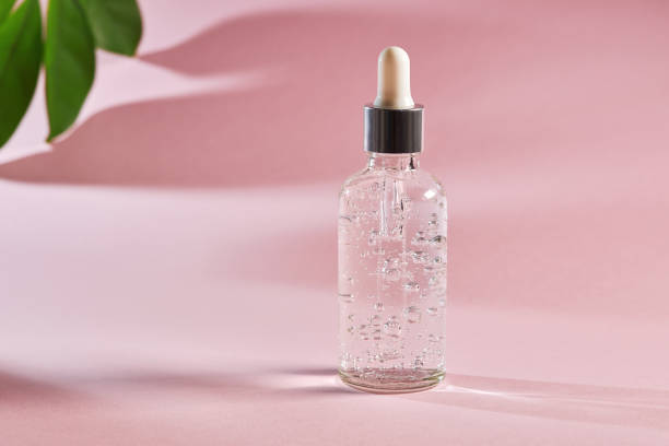 istock Anti aging serum in a glass bottle on a pink background 1298244101