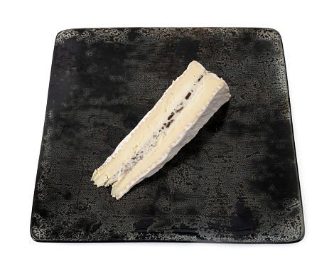 truffled brie cheese in front of white background
