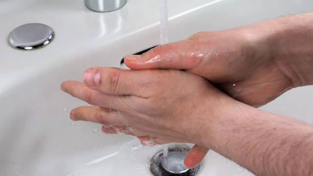 istock Unrecognisable person washing hands 1298246710