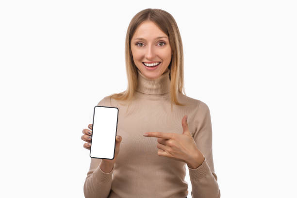 istock Note that. Pretty young blond woman is pointing finger at mobile phone blank screen in her hand 1298247671