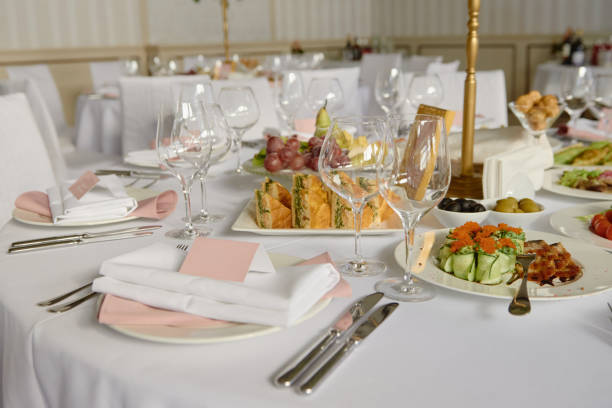 istock Table setting with blank guest card, white plate with pink serviette and cutlery on table, copy space. Place setting at wedding reception. Table served for wedding banquet in restaurant 1298247956