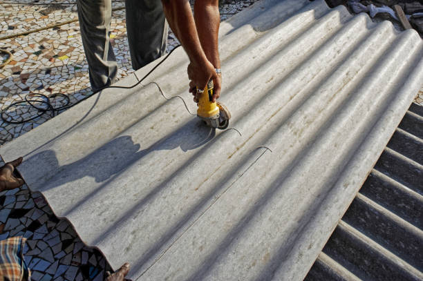 istock Corrugated Asbestos Cement Roof sheet cutting by work man 1298248037