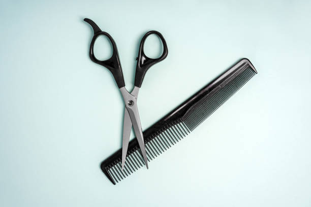 istock Hairdressing tools scissors lie on a blue background 1298248096