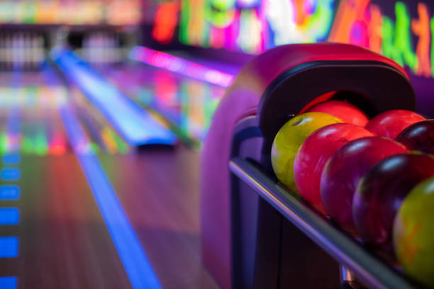 Tenpin balls with blurred alley in background Close up shot of balls in bowling alley ten pin bowling stock pictures, royalty-free photos & images