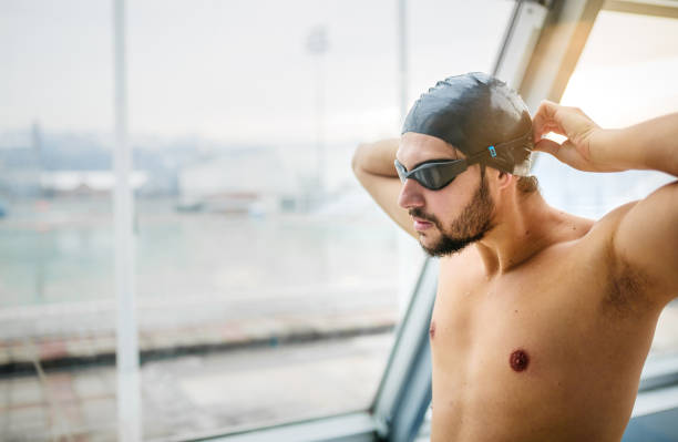 istock Swimmer preparing goggles for swimming 1298251800