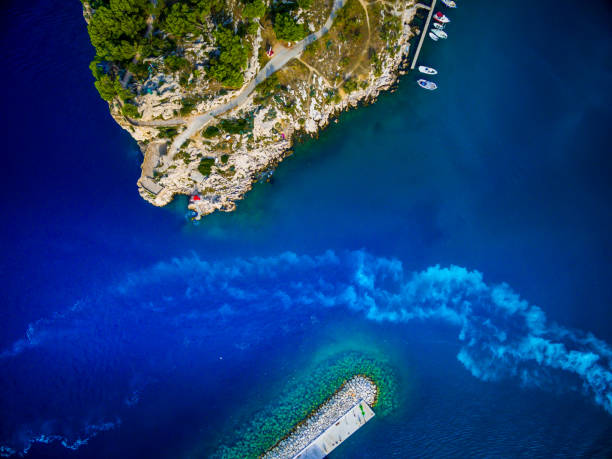 Aerial view of ship left trails in a blue sea and harbour in Croatia, Makarska
