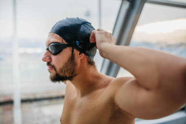 istock Swimmer preparing goggles for swimming 1298252216