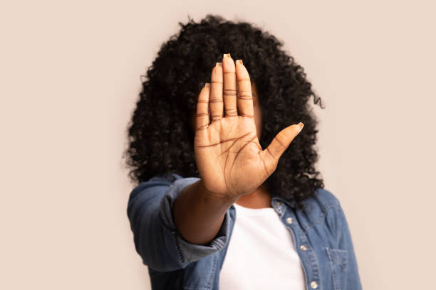 istock Black woman showing her palm, hiding face from camera 1298252441