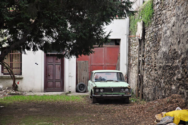 istock An old car at an old house 1298253499