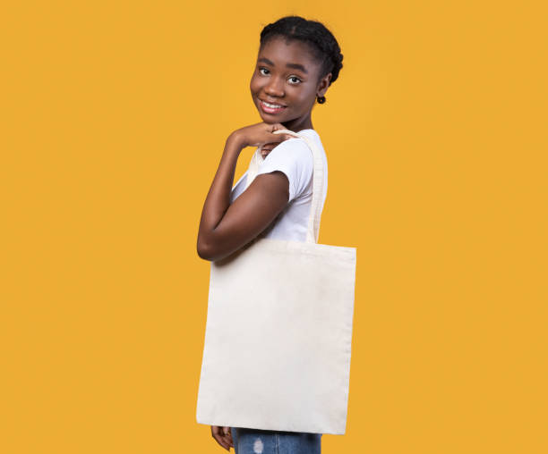 istock Black Lady Posing With Eco Bag Standing On Yellow Background 1298254173