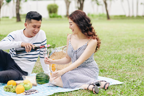 istock Couple enjoying good wine at picnic 1298254286