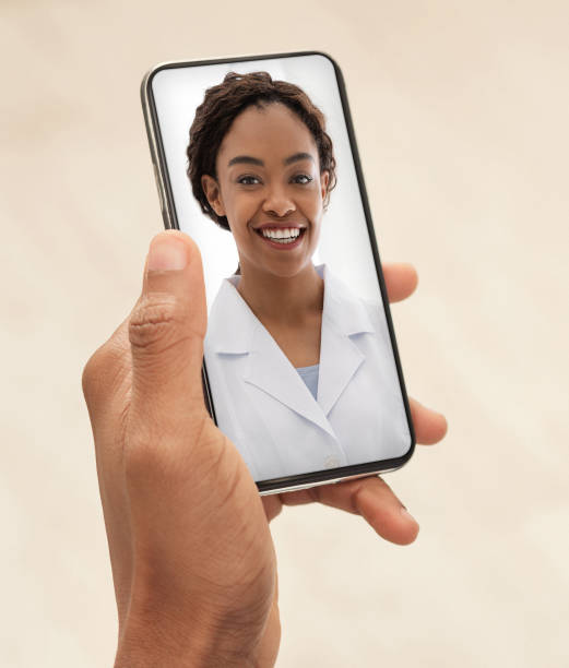smiling black female doctor consulting patient via video call on smartphone. - doctor patient greeting talking imagens e fotografias de stock