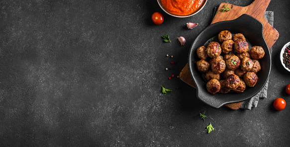 Fryed meatballs on black background, top view, copy space. Beef roasted meatballs on ready for eat.