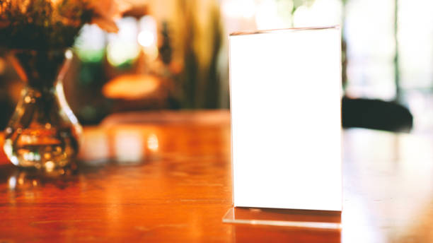 istock cafe menu. Menu frame standing on wood table in Bar restaurant cafe. space for text marketing promotion 1298256802
