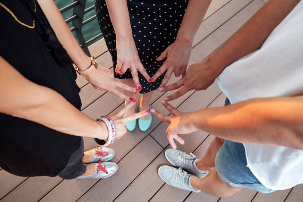 istock Friends holding hands - concept for togetherness and strength. 1298256840